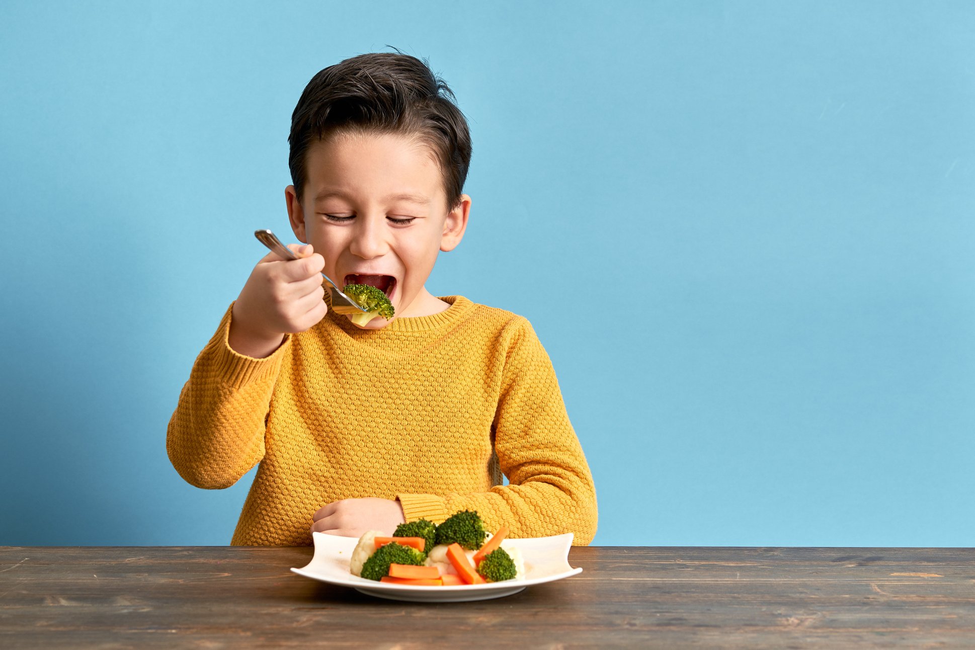 Child is eating vegetables.